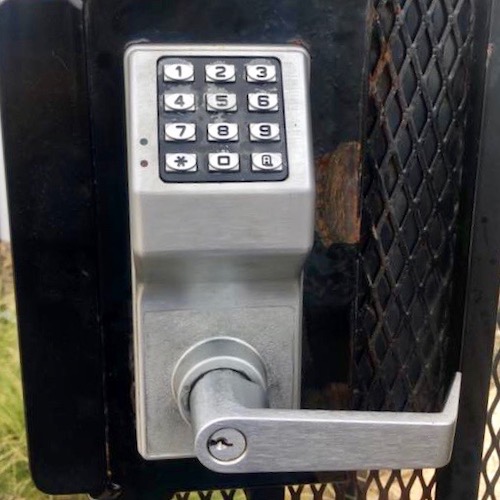 simplex push button lock with key override on black gate